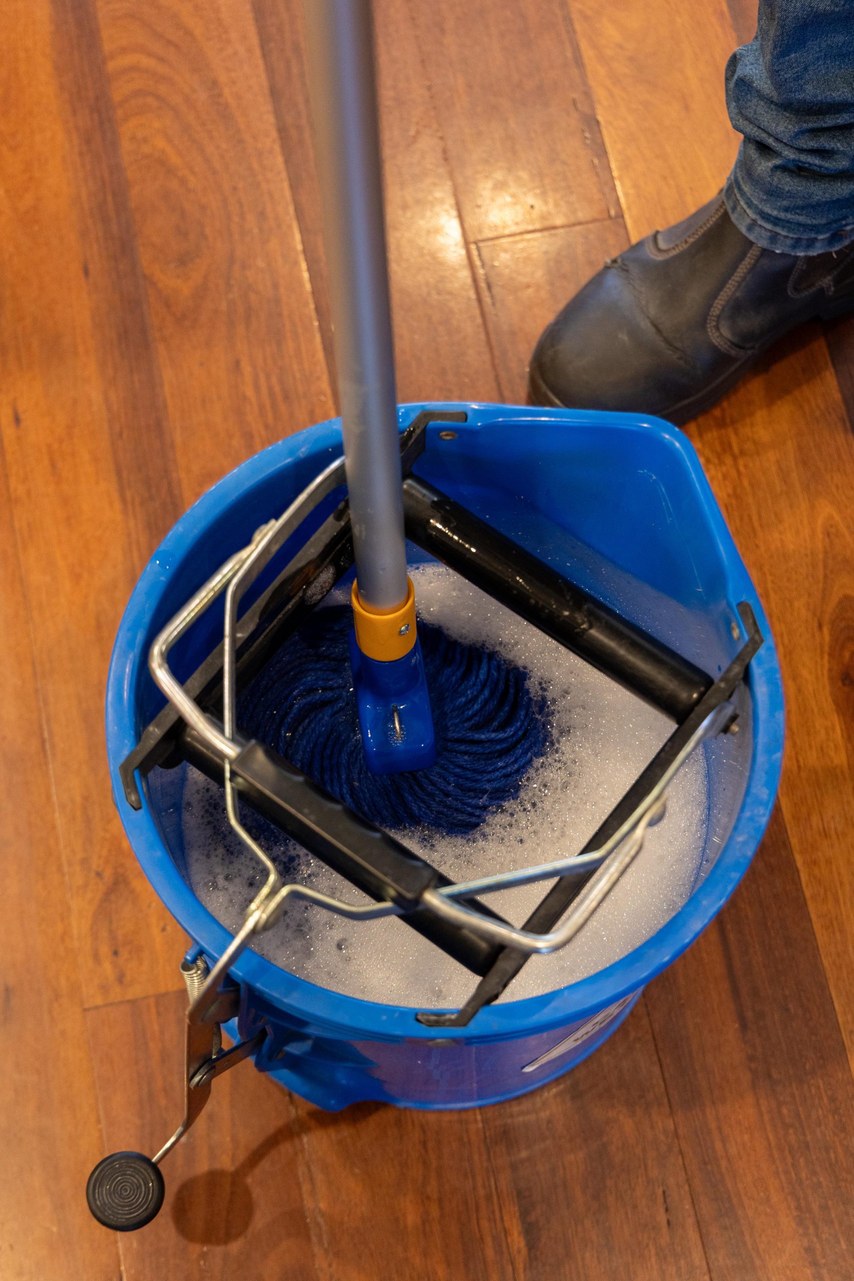 mop being dunked into a mop bucket