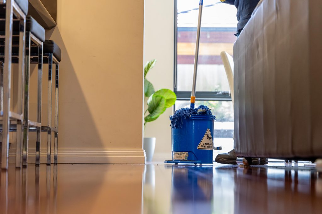 a blue mop bucket with a mop inside of it