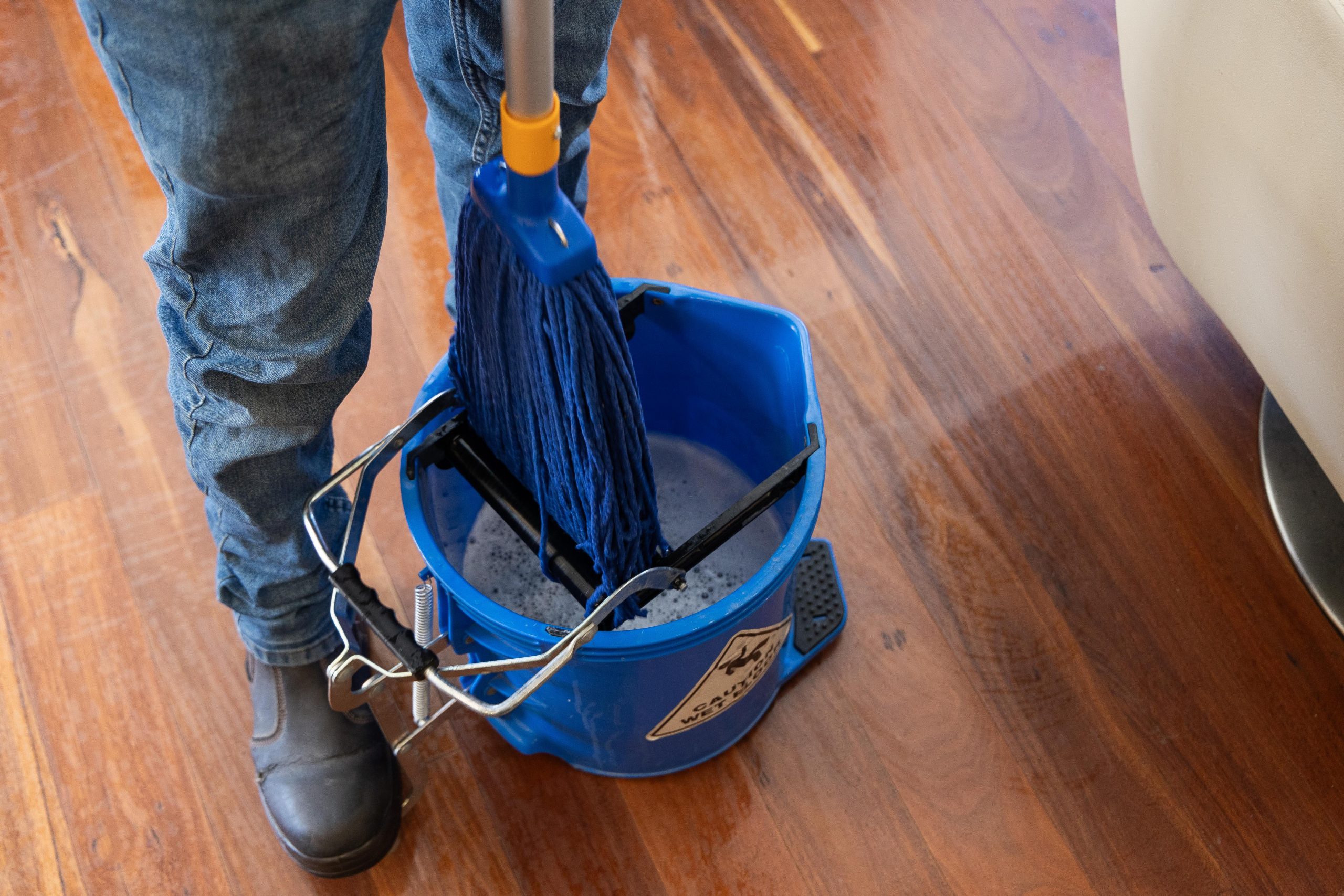 a cleaner using a mop bucket